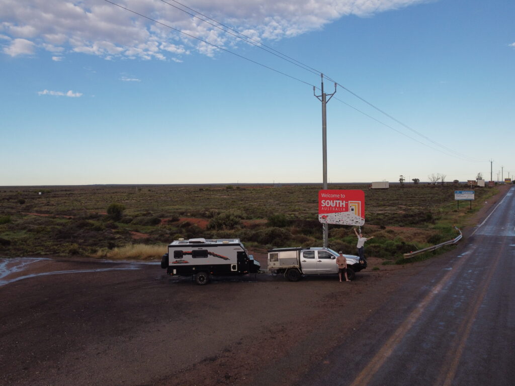 Image of Austrack Campers Caravan next to Welcome to South Australia Sign